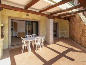 a dining room with a table and chairs on a patio at Baia Del Faro in Palau +83 photos