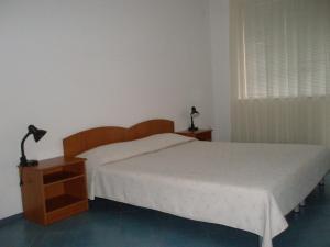 A bed or beds in a room at Family Hotel Maritime