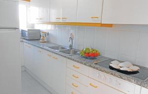 a kitchen with a sink and a bowl of fruit at Awesome Apartment In Blanes With Kitchen in Blanes