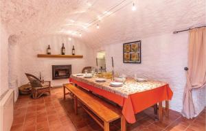 a dining room with a table and a fireplace at Nice Home In Fontanar With Wifi in Fontanar
