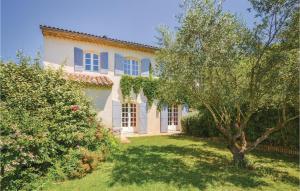 a large house with a tree in the yard at Mas Melusine in Caderousse