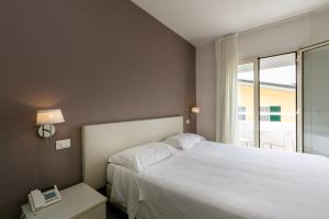 Postel nebo postele na pokoji v ubytování Hotel Saviola