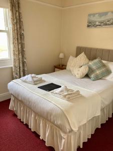 a bedroom with a white bedspread and a white comforter at The Mayfair in Weymouth