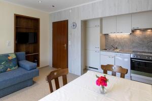 a kitchen and living room with a table and a couch at Apartments Wandaler in St Georgen am Kreischberg in Sankt Georgen ob Murau