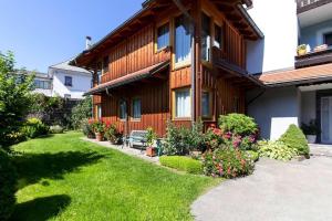 a house with a green lawn in front of it at Apartments Wandaler am Kreischberg in Sankt Georgen ob Murau