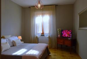 a bedroom with a large bed and a window at Omodarme52 in Pisa
