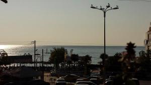 a parking lot with cars parked next to the ocean at Philippos & Maria Apartments in Paralia Katerinis