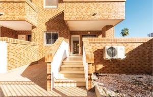 a brick building with stairs in front of it at Pet Friendly Apartment in Oropesa del Mar