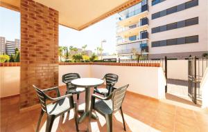 a patio with a table and chairs on a balcony at Pet Friendly Apartment in Oropesa del Mar +14 photos