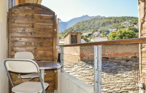 a table and chairs on a balcony with a view at Stunning Apartment In Bastia in Bastia