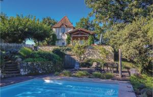 a house with a swimming pool in front of a house at Amazing Home In Beauville With 6 Bedrooms, Wifi And Outdoor Swimming Pool in Beauville