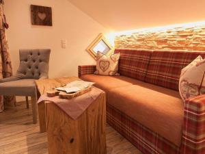 a room with a bed and a couch and a table at Pension Alpenblick in Pfronten