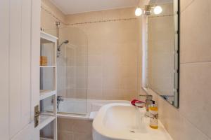 a bathroom with a sink and a bath tub at Townhouse Seraphina in Vale do Lobo +6 photos
