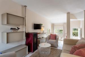 a living room with a couch and a table at Townhouse Seraphina in Vale do Lobo