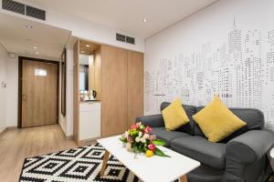 a living room with a couch and a table at Cindyan Serviced Apartments in Al Khobar