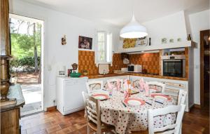 a kitchen with a table with pink candles on it at Lovely Home In Roussillon With Kitchen in Roussillon