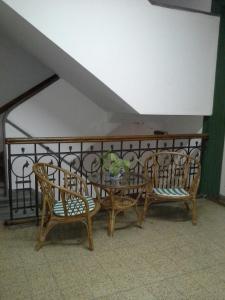 a table and two chairs and a table and a fence at Hotel del Prado in Buenos Aires