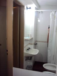 a bathroom with a sink and a toilet at Hotel del Prado in Buenos Aires