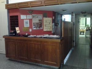 a bar in a restaurant with a red wall at Hotel del Prado in Buenos Aires