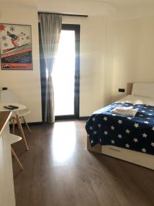 a bedroom with a bed and a table and a door at Marshall Apartment 202 in Gudauri