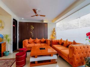 a living room with a couch and a table at Treebo Trend Rejoice 52 in Gurgaon
