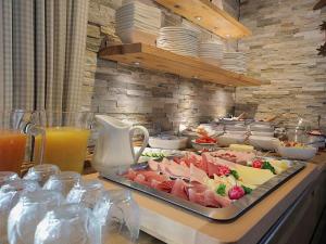 a buffet with a tray of food on a table at Landhaus am Rosenbächle in Pfronten