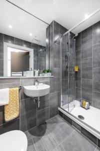 a bathroom with a sink and a shower and a tub at Yugo Highfield Park - Dublin City in Dublin