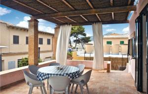 a patio with a table and chairs on a balcony at Nice Home In San Telmo With 3 Bedrooms in Sant Elm