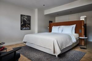 a bedroom with a large bed with white sheets at Solo Sokos Hotel Torni Helsinki in Helsinki