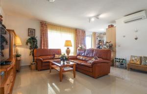 a living room with two leather couches and a coffee table at Cozy Apartment In Denia With Wifi in Denia