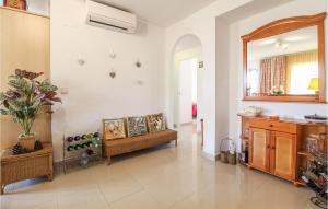 a living room with a couch and a mirror at Cozy Apartment In Denia With Wifi in Denia