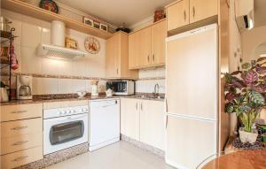 a kitchen with white appliances and a white refrigerator at Cozy Apartment In Denia With Wifi in Denia +19 photos