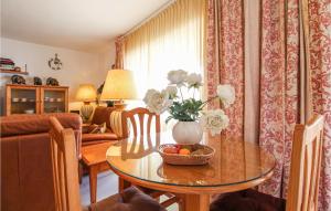 a living room with a table with a bowl of fruit on it at Cozy Apartment In Denia With Wifi in Denia