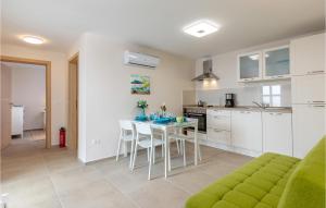 a kitchen and living room with a table and chairs at Cozy Home In Lovran With Wifi in Lovran