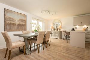 a kitchen and dining room with a table and chairs at Kingsbarns Village Green - Walk to Beach - Parking in Kingsbarns