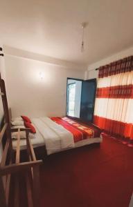 A bed or beds in a room at Green Gregory Villa Nuwara Eliya