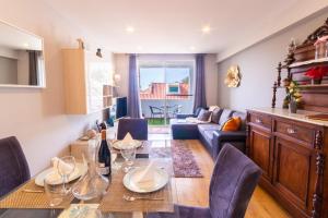 a dining room and living room with a table and chairs at Maria Casa Branca by ALMA Holiday Rentals in Funchal