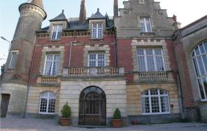 an old brick building with a large tower at Amazing Home In Marconne With Kitchen in Marconne