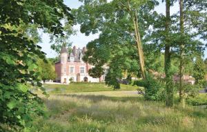 a castle in the middle of a field with trees at Awesome Home In Marconne With 6 Bedrooms And Wifi in Marconne