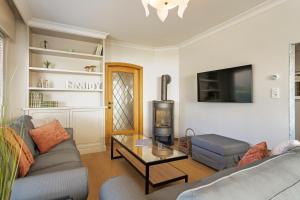 a living room with a couch and a table at Maison Emile in De Panne