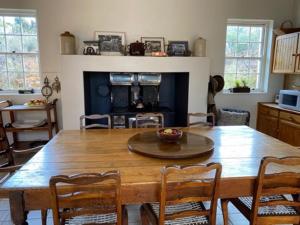 a kitchen with a large wooden table and chairs at Dwarsvlei Guest Farm in Middelburg