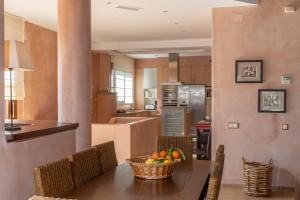 a kitchen with a table with a bowl of fruit on it at Villa Lila in Benalup Casas Viejas
