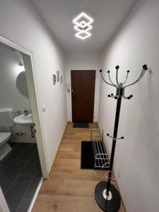 a hallway with a bathroom with a toilet and a sink at Vidaoro Studio Flat in Zell am See