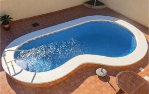 a large swimming pool in a building at Beautiful Home In Quesada-Rojales in Rojales