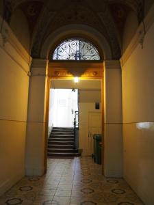 an entrance to a building with a window and stairs at Sakuranbo - Hostel in Budapest