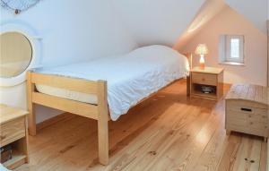 a bedroom with a bed and a mirror and wooden floors at 2 Bedroom Amazing Apartment In Ponts in Ponts +29 photos