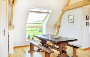 a dining room with a table and a window at 2 Bedroom Amazing Apartment In Ponts in Ponts