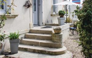 a set of stairs in front of a house with an umbrella at Gorgeous Apartment In Arromanches in Arromanches-les-Bains +17 photos