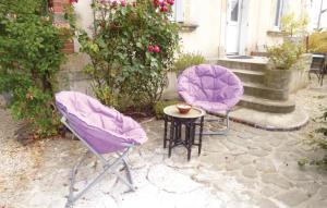 two chairs and a table in a yard at Gorgeous Apartment In Arromanches in Arromanches-les-Bains