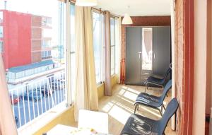 a room with a balcony with chairs and a window at Cozy Apartment In Alicante With Wifi in Alicante